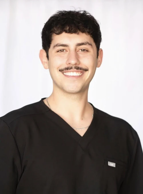 A professional photo of Dr. Anthony Ferrara wearing scrubs
